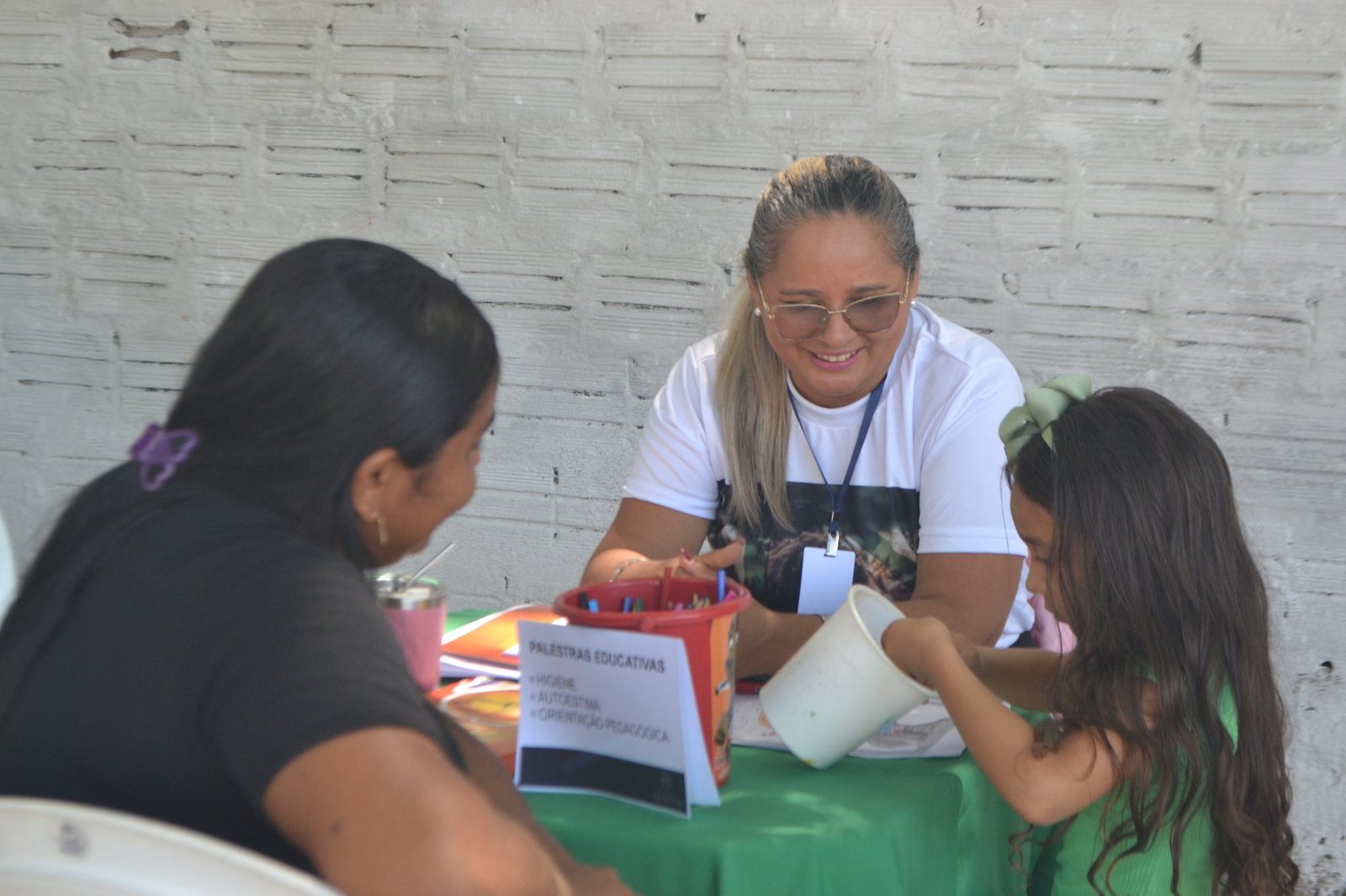 Voluntária em atividade de pintura com uma criança durante o Dia D Hebrom